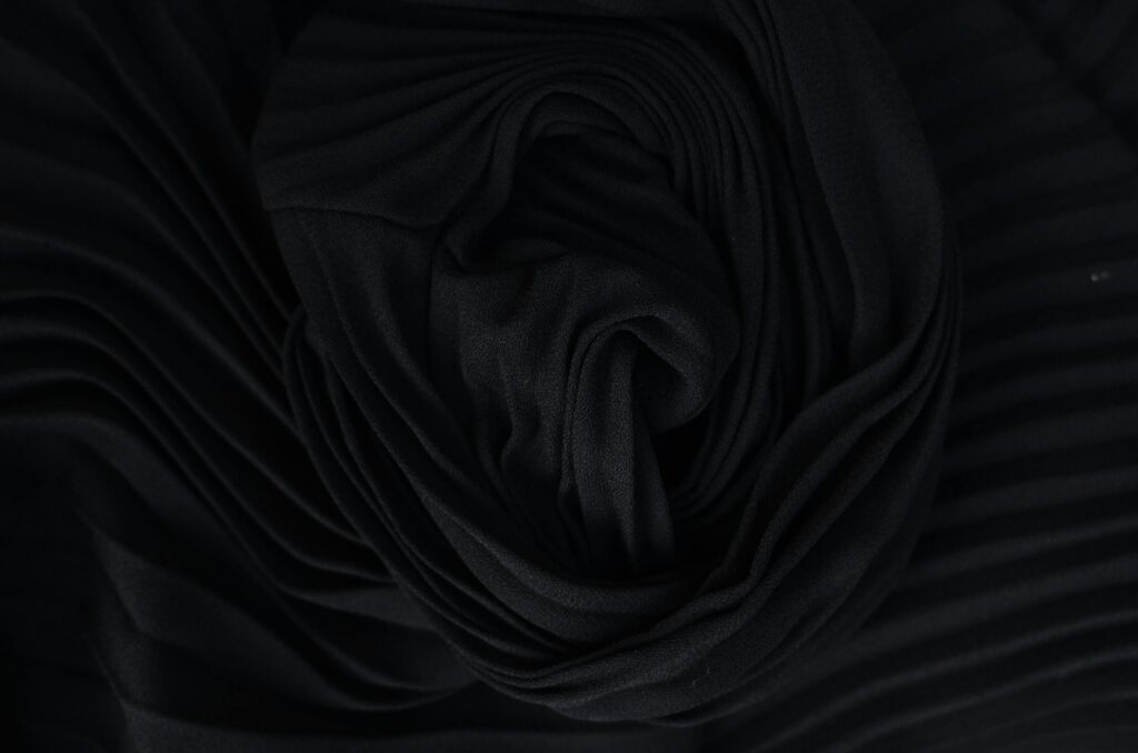 pexels photo 6044198 6044198 Top view of abstract background representing wavy creased black silk fabric in twilight